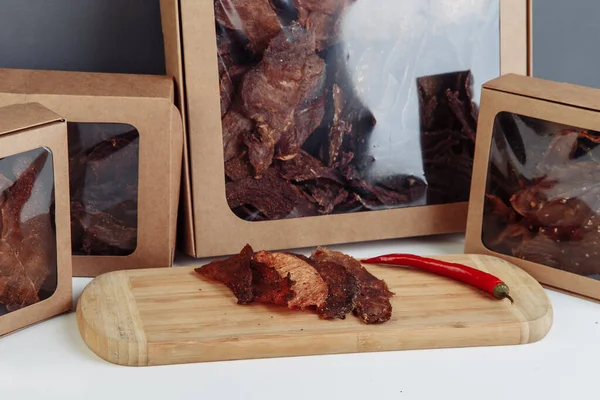 Beef jerky snack high in protein, lean meat. smoked, dried food. dark background. High quality photo