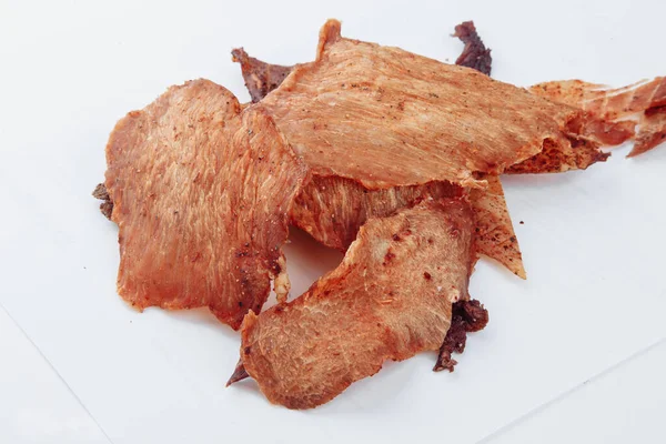 Close-up shot of a dry-aged man carefully slicing a tender dry-aged beef brisket to be served at a barbecue restaurant. on a white background. High quality photo