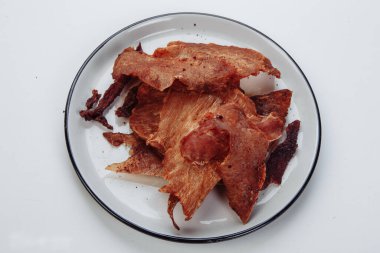 Çerçevelenmiş eti yakın plan yap. Küçük, ince parçalar üçgenlere bölünmüş.