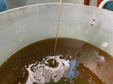 Bal çömleğe dökülür. Büyük bir sarnıçta bal. Yüksek kalite fotoğraf