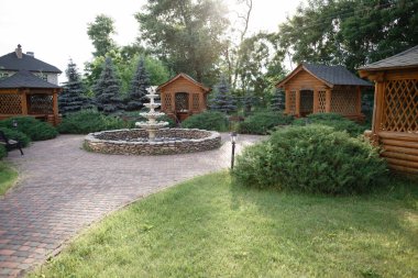 Private backyard living surrounded with flower Garden and pergola for hot summer days. Relaxing, peaceful and beautiful. fountain. High quality photo