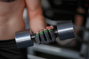 Sports background. Young athlete getting ready for crossfittraining. Powerlifter hand in talc preparing to training. High quality photo