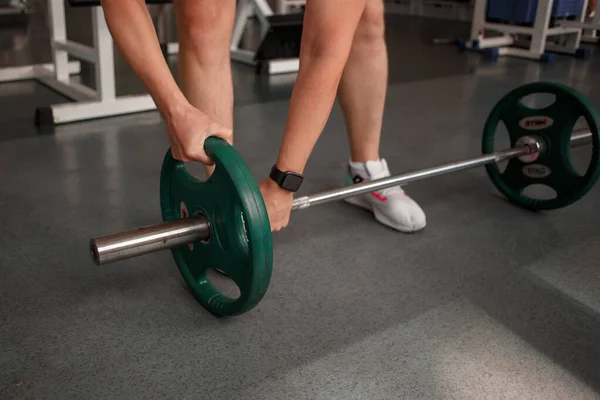 fitness ,workout, gym exercise ,lifestyle and healthy concept.Woman in exercise gear standing in a row holding dumbbells during an exercise class at the gym.Fitness training with kettlebell in sport