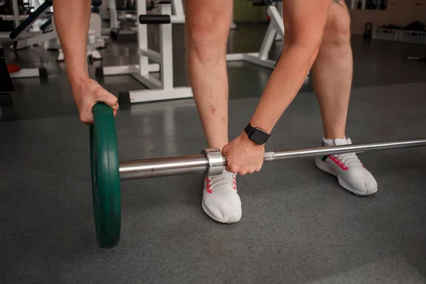 stock image fitness ,workout, gym exercise ,lifestyle and healthy concept.Woman in exercise gear standing in a row holding dumbbells during an exercise class at the gym.Fitness training with kettlebell in sport