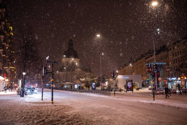Stockholm, Sweden - January 06, 2023: Gustaf Vasa Church (Odenplan) on winter evening during snowfall
