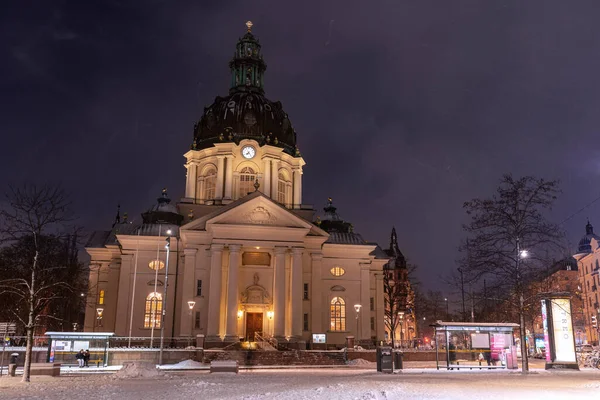Stockholm, Sweden - January 06, 2023: Gustaf Vasa Church (Odenplan) on winter evening during snowfall