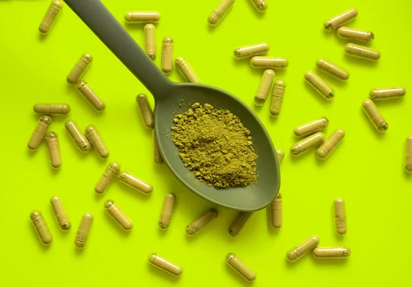 stock image kratom pills composition on yellow background with kratom filled 