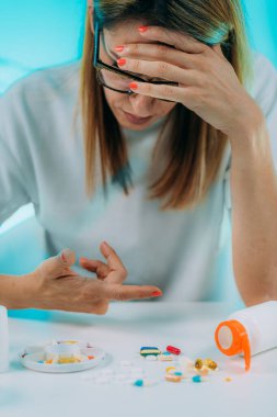 Reçeteli ilaç bağımlılığı. Kadın hasta hapları sayıyor.. 