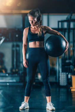 Duvar Topu ile egzersiz yapan bayan sporcu.
