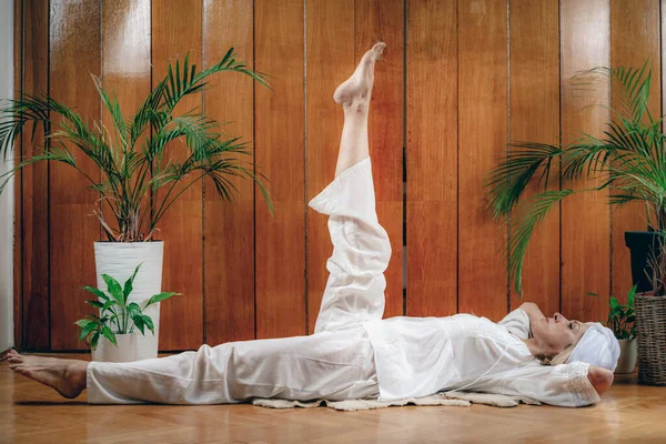 stock image Woman practicing Kundalini Yoga, Kriya exercises for the navel center and bowel waste elimination  