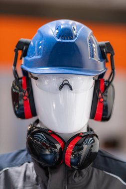 PPE - Industrial Work Safety and Personal Protection Equipment on Display. Safety helmet and anti-noise earmuffs