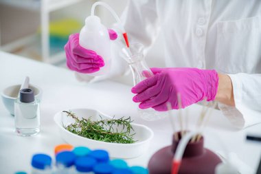 Aromacology Expert Preparing Flask with Fragrance Ingredients