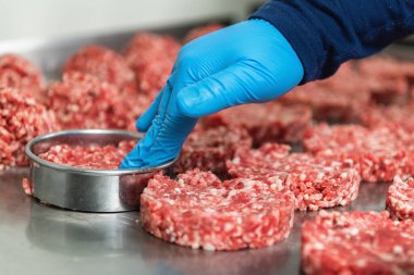 Hand of a chef preparing burgers, close up	 clipart