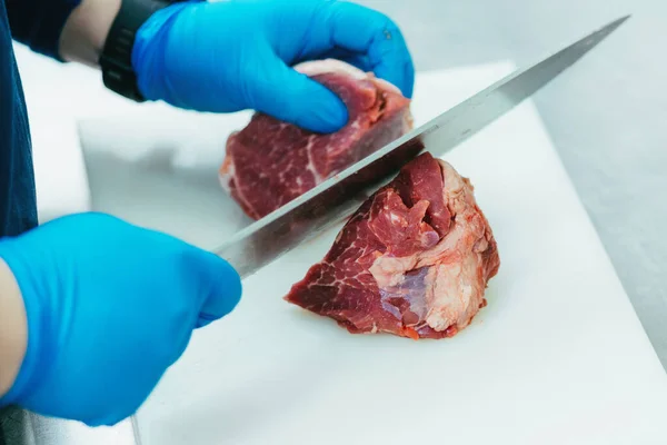 シェフが切り盛りし 大きなレストランでナイフで赤牛の肉の作品を準備 — ストック写真