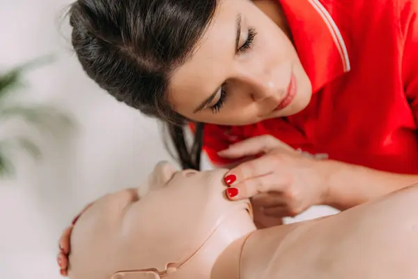 stock image CPR with mouth to mouth technique in a first aid course using a training dummy.