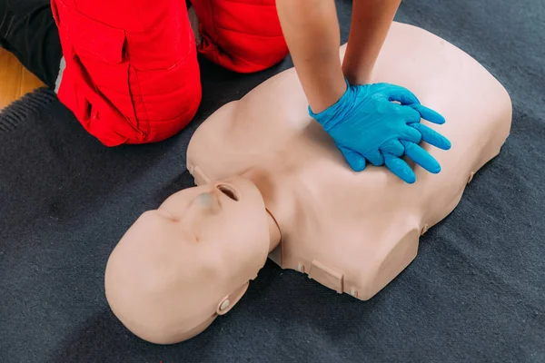 CPR Training Course. Chest compression techniques in a CPR first aid training with a dummy.