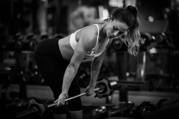Woman doing Strength training, female athlete exercising in the gym