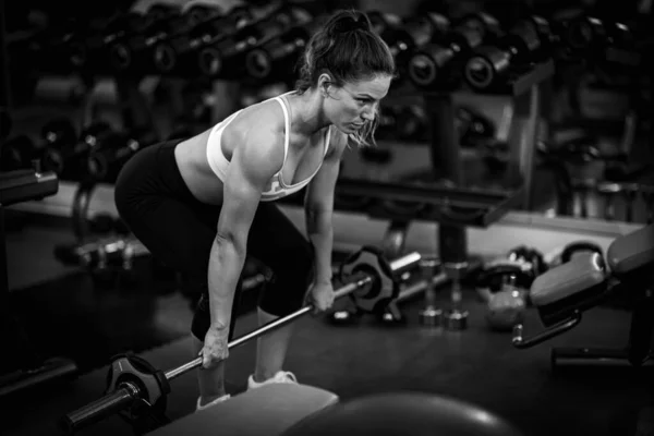 Woman doing Strength training, female athlete exercising in the gym