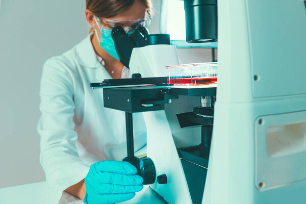  Female scientist researching samples in laboratory