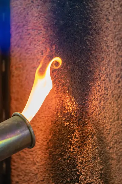 stock image Close up of a flame testing fire retardant material, highlighting fire safety, heat resistance, and material testing in a controlled environment