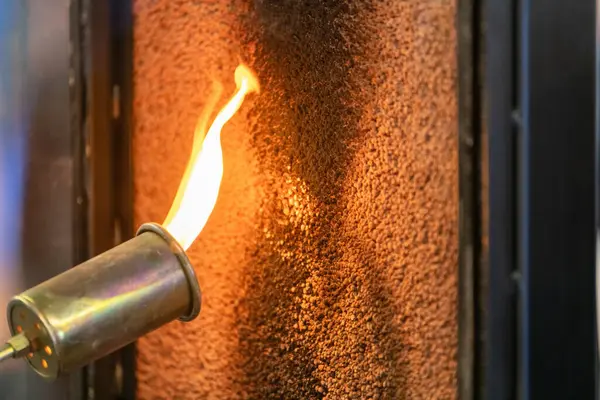 stock image Close up of a flame torch testing flame retardant material, demonstrating fire resistance and safety