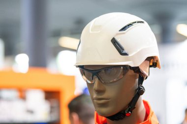 Gerekli güvenlik teçhizatlarıyla donatılmış bir manken. Kasketi ve renkli güvenlik gözlükleri de dahil. İnşaat veya endüstriyel güvenlik ekipmanları için ideal