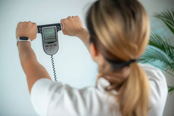 stock image Woman using body fat scale for weight measurement.