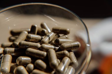 Haplar, kapsüller, antibiyotikler. Hastalık önleme. Soğuk algınlığı ve grip tedavisi. Coronavirus. Reseptör ilaçları. Beyaz ve yeşil haplar. Haplar bir adamın elinde.