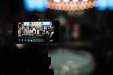 Cleveland, OH, USA - 05.15.2022: Kilisede canlı yayın. Kameranın arkasındaki operatör canlı yayın yapıyor. Telefonundan sosyal ağlarda çevrimiçi video. Video konferansı.