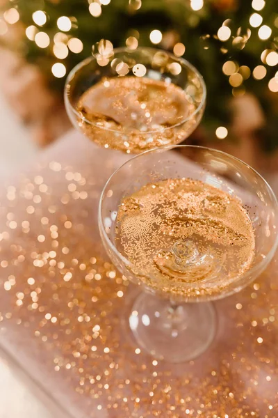New Year\'s Eve 2022-2023 Celebration  Background with Champagne. Champagne glasses on glitter background. Three champagne glasses ready to bring in the New Year.