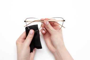 Cleaning glasses. The woman wipes her glasses with a cloth