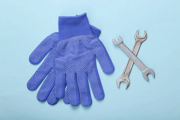 仕事の整備士の概念 青の背景にレンチで手袋を作業します トップ表示 — ストック写真