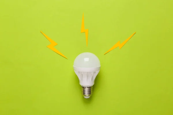 Led light bulb with sparks on a green background. Creative idea concept