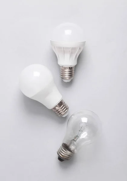 Led light bulbs and incandescent bulb on gray background. Top view