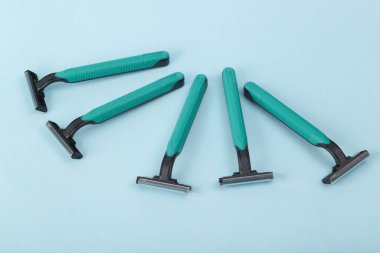 Plastic razors on a blue background.