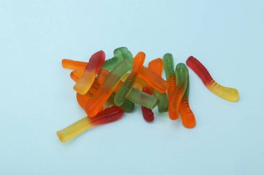 Jelly colored worms on a blue background