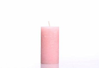 Pink wax candle isolated on white background