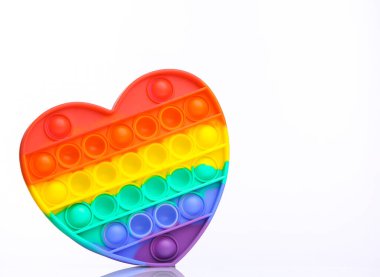 Popular antistress pop it toy in the shape of heart isolated on white background