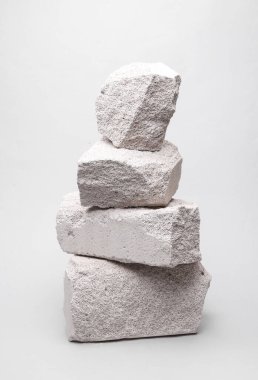 Minimalistic composition with natural porous white stones on a gray background