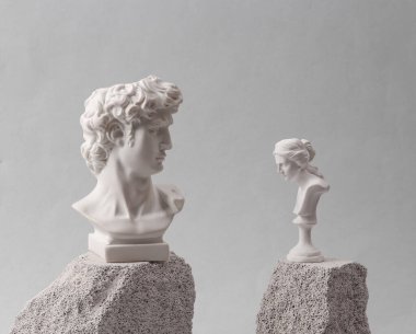 Minimalistic scene of antique bust of David and Venus on stones