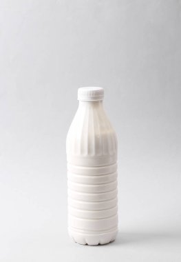Mockup white plastic bottle of yogurt or milk on gray background