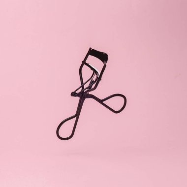 Professional eyelash curler  isolated on pink background