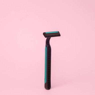 plastic razor flying in antigravity on pink background with shadow. Levitation object in the air. Beauty and fashion concept. Creative minimal layout