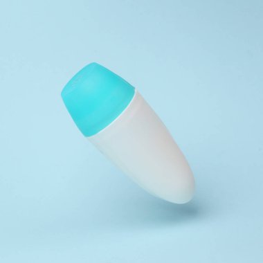 Antiperspirant stick mockup flying in antigravity on blue background with shadow. Levitation object in the air. Beauty concept. Creative minimal layout