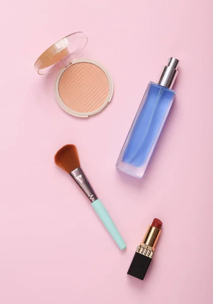 Cosmetic products on a pink background. top view