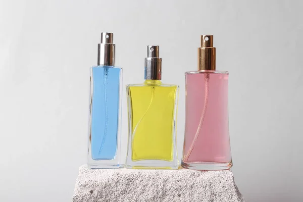 Natural cosmetic. Beauty products. Perfume bottles on stone, gray background. Product photo. Abstract natural composition