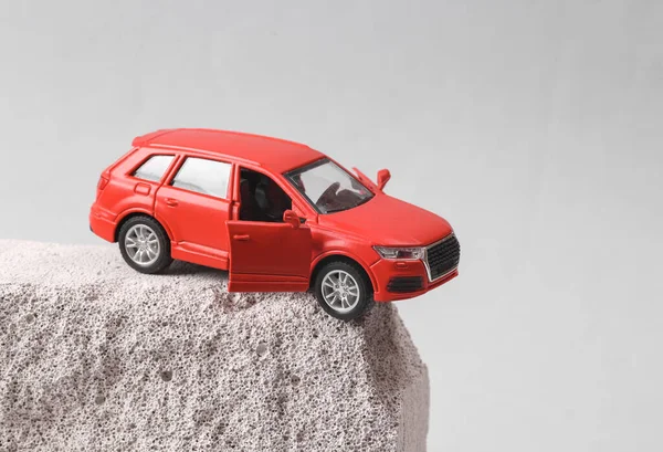 Miniature car on a stone cliff