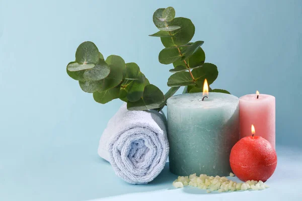 Spa, relaxation. aroma therapy concept. Beauty still life. Flaming aroma candles with bath salt, eucalyptus sprig and towel