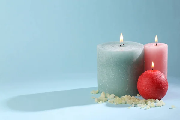 Spa, relaxation. aroma therapy concept. Beauty still life. Flaming aroma candles with bath salt on blue background