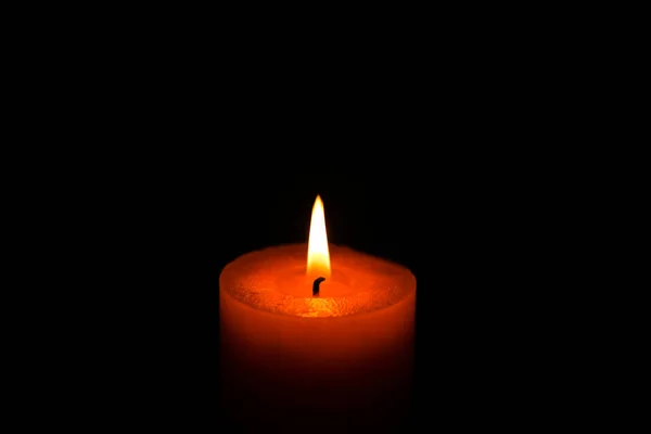 Funeral flaming candle isolated on black background